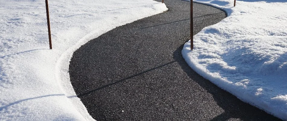 Cleared parking lot in Groton, CT, with piles of snow.