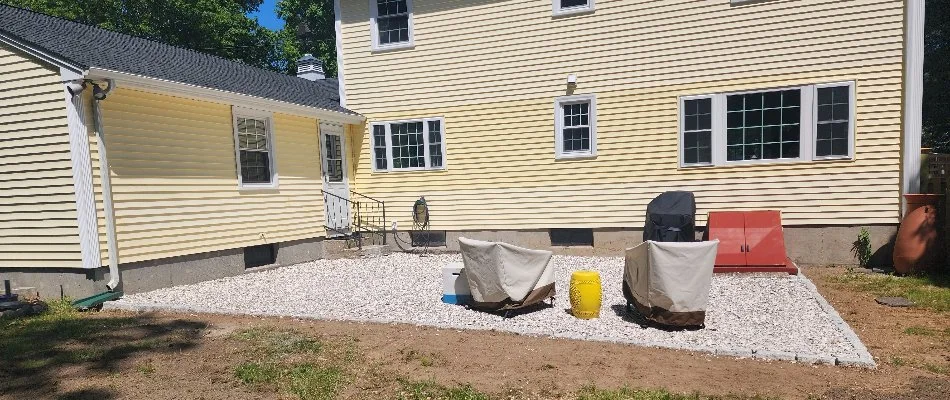 Crushed stone patio along the back of a house in Groton, CT.