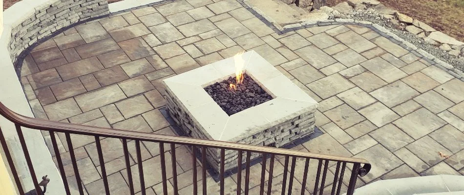 Gas-burning fire pit on a paver patio in Groton, CT.