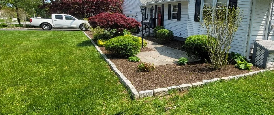 Green lawn and landscape with lush plants in Mystic, CT.