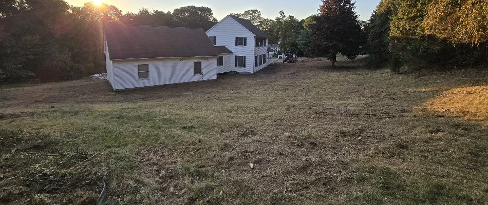 Land next to a house in Groton, CT, after clearing.