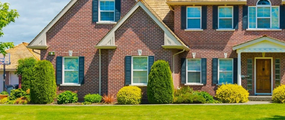 Manicured trimmed shrubs by a house in Pawcatuck, CT.