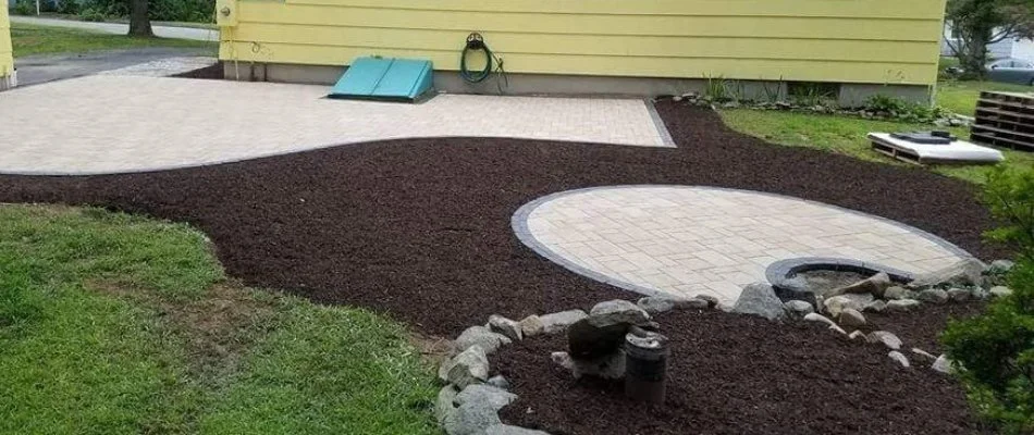 Mulched area around a paver patio in Willimantic, CT.
