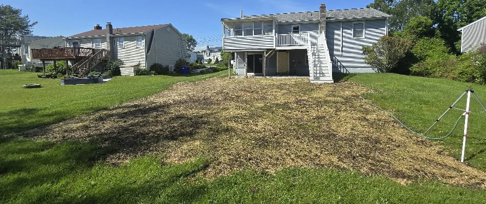 Land next to a house in Groton, CT, after clearing.