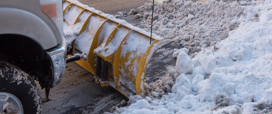 Snowy road in Groton, CT, being plowed.