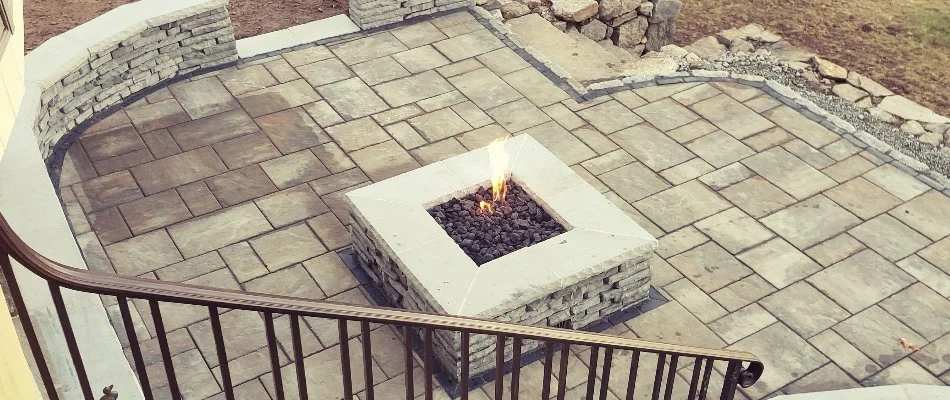 Square fire pit on a paver patio in Groton, CT.