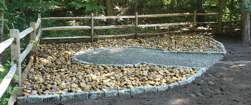 Tan rocks around a gravel area in Groton, CT.