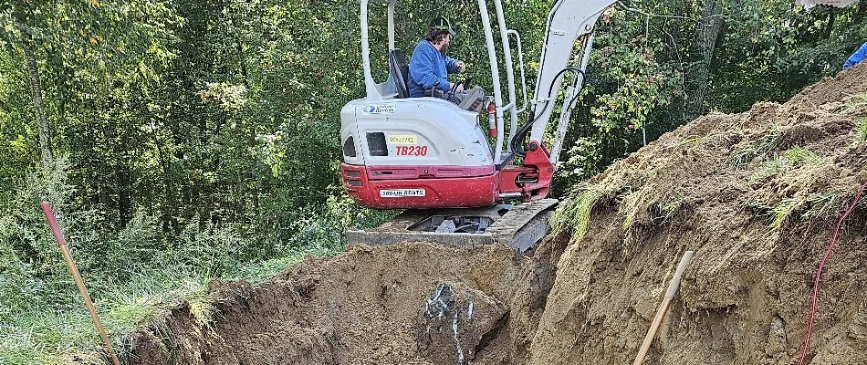 Worker using machinery to prep a site in Mystic, CT.